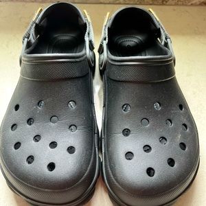 Black unisex Crocs with an outdoor/ bigger strap. Mens size 9, Women’s size 11.